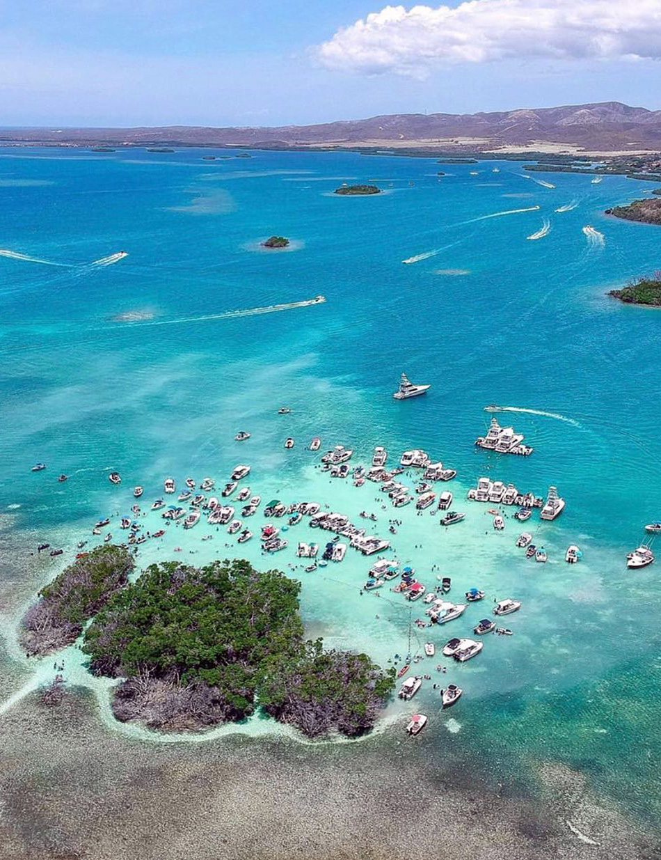 Aerial view of boats and turquoise water at Isla Caracoles near La Parguera